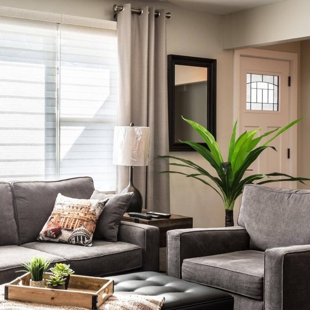 Living room entrance with sofa, chair and sheer shades closed